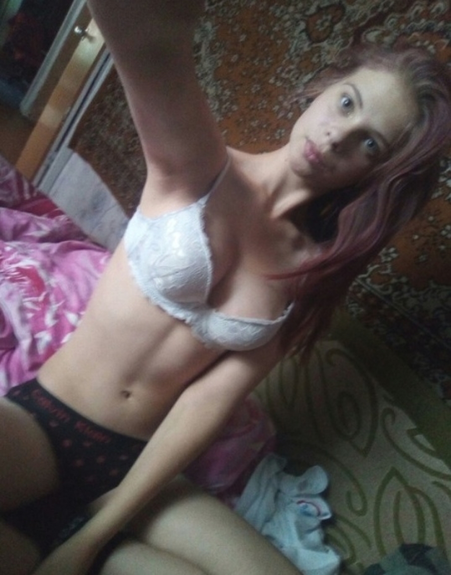 Young girl in her beedroom in bra only